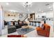 Open-concept living room features a modern design, seamlessly connecting to the kitchen and dining area at 7614 Oak Spring Ln, Davenport, FL 33837