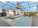 Sparkling pool area with lounge chairs and sunshades inside of a screened lanai, offering a relaxing outdoor oasis at 7614 Oak Spring Ln, Davenport, FL 33837