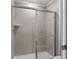 Bathroom featuring gray tile shower with sliding glass door at 7614 Oak Spring Ln, Davenport, FL 33837