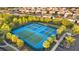 An aerial view showcases several tennis courts surrounded by green landscaping at 7614 Oak Spring Ln, Davenport, FL 33837