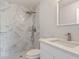 Bathroom with a modern vanity, shower, and marble-look tile on the walls at 2680 Sw 144 Ct, Ocala, FL 34481