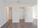 Bedroom featuring wood-look flooring and doorways leading to a bathroom and closet at 2680 Sw 144 Ct, Ocala, FL 34481