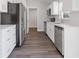 Beautiful kitchen with stainless steel appliances, white cabinets, and modern wood flooring at 2680 Sw 144 Ct, Ocala, FL 34481