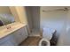 Well-lit bathroom featuring vanity with sink, toilet, and tile shower at 2818 Dellwood Dr, Orlando, FL 32806
