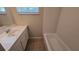 Bathroom featuring a vanity, tub with tiled walls, and tile flooring at 2818 Dellwood Dr, Orlando, FL 32806