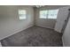 Clean bedroom with carpet, neutral walls, large windows and a ceiling fan at 2818 Dellwood Dr, Orlando, FL 32806