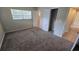 Cozy bedroom with neutral walls, plush carpeting, a window for natural light, and a closet at 2818 Dellwood Dr, Orlando, FL 32806