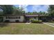 Charming single-story home featuring a carport, well-maintained lawn, and fresh landscaping at 2818 Dellwood Dr, Orlando, FL 32806