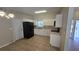 Bright kitchen boasts white cabinets, black appliances, tiled flooring, and ample counter space at 2818 Dellwood Dr, Orlando, FL 32806
