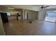 Spacious living room featuring tile floors, white trim and neutral paint with an adjacent open concept kitchen at 2818 Dellwood Dr, Orlando, FL 32806