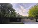 A rear exterior view shows the spacious yard and abundant windows for natural light at 2818 Dellwood Dr, Orlando, FL 32806