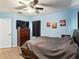 Blue bedroom featuring a ceiling fan, neutral walls, and three racecar picture frames at 3125 Kearns Rd, Mulberry, FL 33860