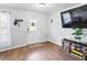 Cozy entryway with wood floors, white door, and ample natural light from a nearby window at 3125 Kearns Rd, Mulberry, FL 33860