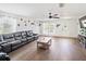 Comfortable living room features wood floors, a plush gray couch, and a ceiling fan at 3125 Kearns Rd, Mulberry, FL 33860