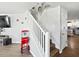 Bright staircase leading to upper level with white railing and wood stairs at 3125 Kearns Rd, Mulberry, FL 33860