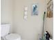 Bathroom with a white toilet and a jellyfish art piece on the wall at 4836 Pebble Beach Dr, Orlando, FL 32811