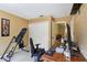 Bedroom featuring a closet, desk, cushioned chair, and exercise equipment at 4836 Pebble Beach Dr, Orlando, FL 32811
