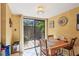 Eat-in dining area with wood table and chairs, sliding glass door leading to outdoor patio at 4836 Pebble Beach Dr, Orlando, FL 32811