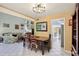 Dining area with a wooden table, chairs, chandelier, and easy access to the kitchen and living room at 4836 Pebble Beach Dr, Orlando, FL 32811
