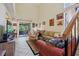 Inviting living room with vaulted ceiling, tile flooring, and sliding door access to the lanai at 4836 Pebble Beach Dr, Orlando, FL 32811