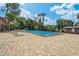 A sunny pool with tiled deck and lounge chairs, ideal for relaxation and recreation in a private setting at 4836 Pebble Beach Dr, Orlando, FL 32811