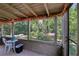 Screened porch with bistro table, offering serene views of lush greenery and calm waters at 4836 Pebble Beach Dr, Orlando, FL 32811