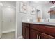 Bathroom featuring double sinks, a spacious shower, and neutral colored walls at 6889 Wilson Hammock Ave, Groveland, FL 34736
