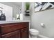 Bathroom with double sinks, marble countertops, and decorative wall art at 6889 Wilson Hammock Ave, Groveland, FL 34736