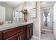 Bright bathroom with double vanity, tile flooring, and framed mirrors at 6889 Wilson Hammock Ave, Groveland, FL 34736