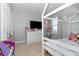 Cozy bedroom features a white dresser and a cute bed at 6889 Wilson Hammock Ave, Groveland, FL 34736