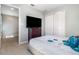 Bedroom displaying neutral walls, cozy carpeting, and a large TV opposite a comfortable bed at 6889 Wilson Hammock Ave, Groveland, FL 34736
