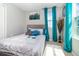 Bright bedroom with a serene ambiance, featuring a plush bed, soft rug, and lots of natural light at 6889 Wilson Hammock Ave, Groveland, FL 34736