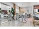 Elegant dining area featuring a mirrored table, velvet chairs and kitchen in background at 6889 Wilson Hammock Ave, Groveland, FL 34736