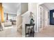 Inviting entryway with neutral walls, modern console table and staircase to upper level at 6889 Wilson Hammock Ave, Groveland, FL 34736