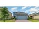 Charming two-story home featuring a two-car garage and a well-maintained front yard at 6889 Wilson Hammock Ave, Groveland, FL 34736