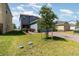 Beautifully landscaped front yard with a brick driveway leading to a two-story home at 6889 Wilson Hammock Ave, Groveland, FL 34736