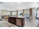 Modern kitchen features granite countertops, stainless steel appliances, and open layout to living area at 6889 Wilson Hammock Ave, Groveland, FL 34736