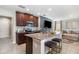 Open kitchen features granite countertops, stainless steel appliances, and breakfast bar seating at 6889 Wilson Hammock Ave, Groveland, FL 34736