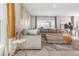Open-concept living room with a spacious sectional sofa, stylish rug and views of dining area at 6889 Wilson Hammock Ave, Groveland, FL 34736