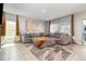 Comfortable living room with a cozy sectional sofa, stylish rug, and bright windows at 6889 Wilson Hammock Ave, Groveland, FL 34736