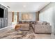 Spacious living room featuring a large sectional sofa, plush rug, and decorative artwork at 6889 Wilson Hammock Ave, Groveland, FL 34736