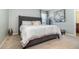 Comfortable main bedroom with a large bed and decorative flower art at 6889 Wilson Hammock Ave, Groveland, FL 34736