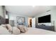 Spacious main bedroom features a large bed, dresser, television, and closet at 6889 Wilson Hammock Ave, Groveland, FL 34736