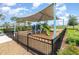 Fenced community playground with a shaded play structure, picnic table, and green space for recreation at 6889 Wilson Hammock Ave, Groveland, FL 34736