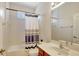 Bathroom featuring a shower-tub combo, a window, a vanity with a single sink and decorative hardware at 13708 Old Dock Rd, Orlando, FL 32828