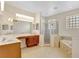 The primary bathroom features dual sinks, a separate shower, and a soaking tub with tile surround at 13708 Old Dock Rd, Orlando, FL 32828