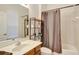 Bright bathroom features a wood vanity, large mirror, and a shower/tub combo with curtain at 13708 Old Dock Rd, Orlando, FL 32828
