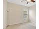 Bright bedroom features neutral walls, carpeted floor, window with blinds, and ceiling fan at 13708 Old Dock Rd, Orlando, FL 32828
