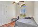 Bedroom features wood floors, arched window above a window with blinds, and ceiling fan at 13708 Old Dock Rd, Orlando, FL 32828