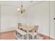 Cozy dining area featuring a modern chandelier, light wood table, and stylish seating for Gathering meals at 13708 Old Dock Rd, Orlando, FL 32828